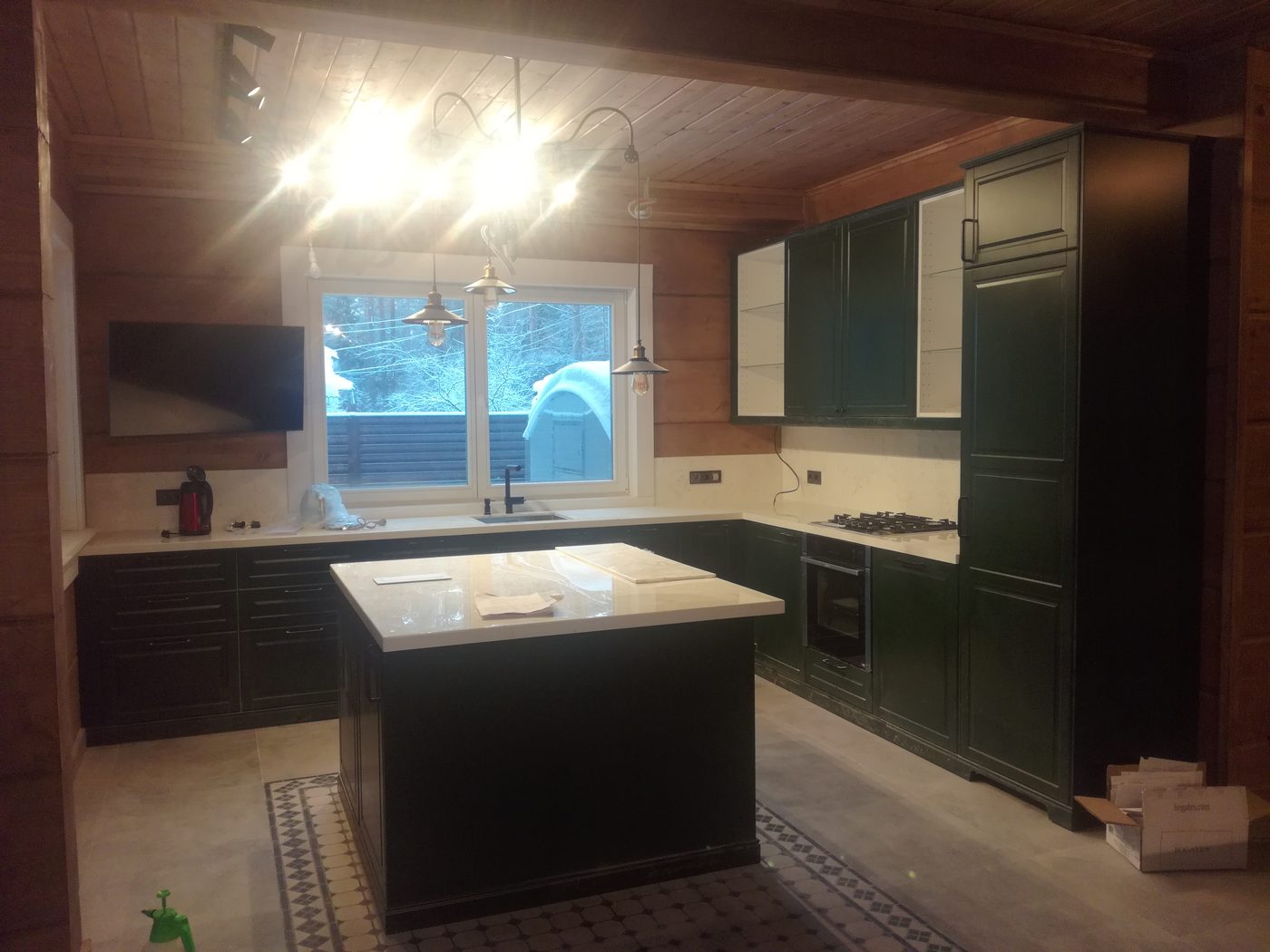 Dark green kitchen in log home